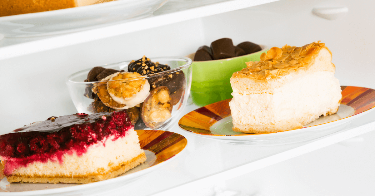 A refrigerator showcasing an assortment of delectable desserts and How long does cheesecake last in the fridge, tempting with their sweet and irresistible appeal.