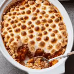 Easy Sweet Potato Casserole topped with golden toasted marshmallows in a white baking dish.