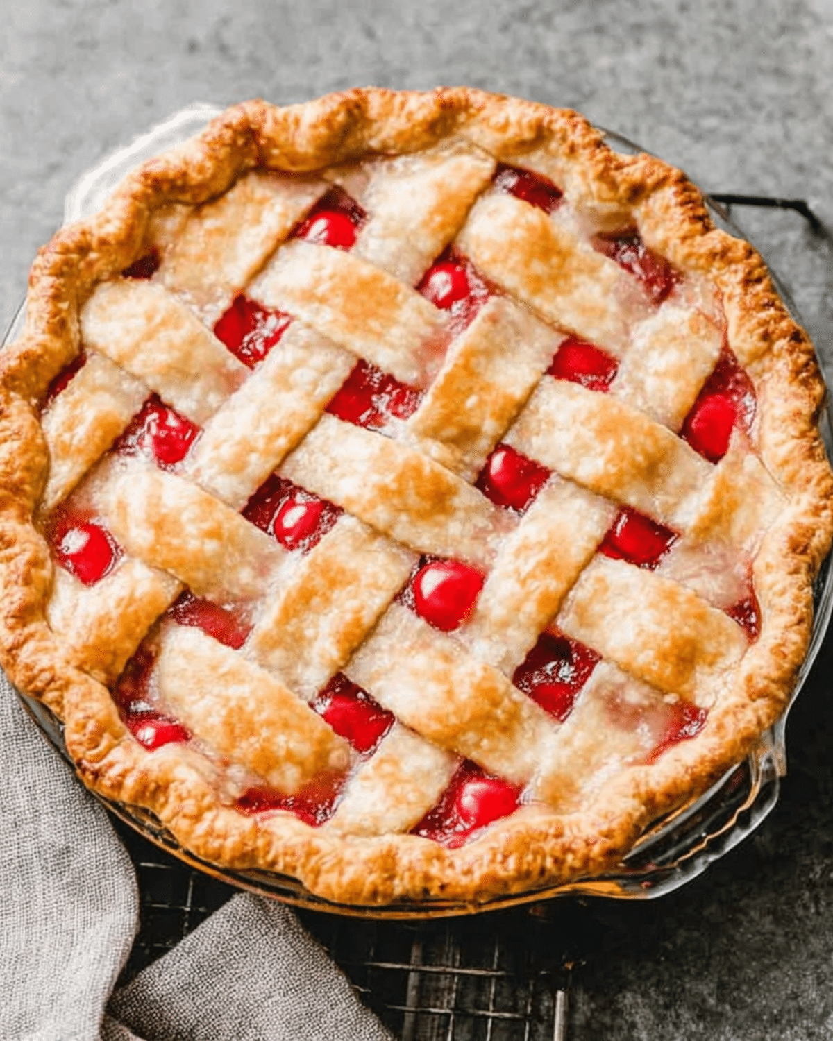 Homemade Cherry Pie with a golden lattice crust in a glass pie dish