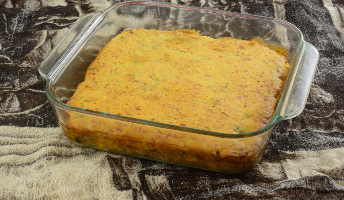 A delicious Cowboy Cornbread Casserole served in a rustic baking dish. The casserole features a golden, crumbly cornbread topping, beautifully baked to a perfect golden brown.
