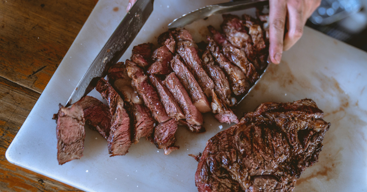 process of cutting a steak, either a prime rib or ribeye, on a chopping board is ready. You can view it to see the distinctive characteristics of each steak cut.