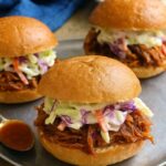 Delicious Slow Cooker Hawaiian Chicken Sandwich topped with creamy coleslaw on a soft bun. Title: Slow Cooker Hawaiian Chicken Sandwich
