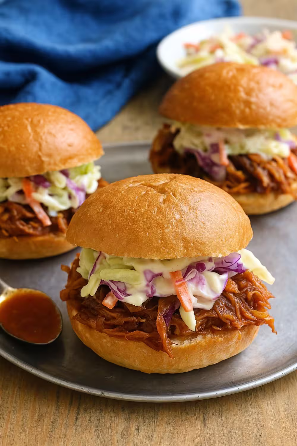 Delicious Slow Cooker Hawaiian Chicken Sandwich topped with creamy coleslaw on a soft bun. Title: Slow Cooker Hawaiian Chicken Sandwich