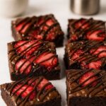 Fudgy chocolate strawberry brownies topped with fresh berries and chocolate drizzle