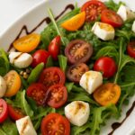 Fresh BJ’s Tomato Mozzarella Salad with arugula, heirloom tomatoes, mozzarella, and balsamic glaze
