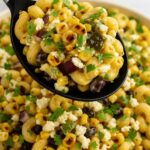 Mexican Street Corn Pasta Salad with grilled corn, black beans, cotija cheese, and fresh cilantro served in a bowl.