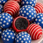 Patriotic Oreo Balls coated in red, white, and blue chocolate, decorated with stars and stripes.