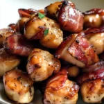 Bowl of maple bacon glazed chicken bites with a glossy, caramelized coating.