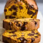 Slices of the best chocolate chip pumpkin bread filled with gooey chocolate chips and moist pumpkin crumb.