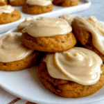 A plate of soft Amish Pumpkin Cookies with Frosting, topped with creamy beige icing.