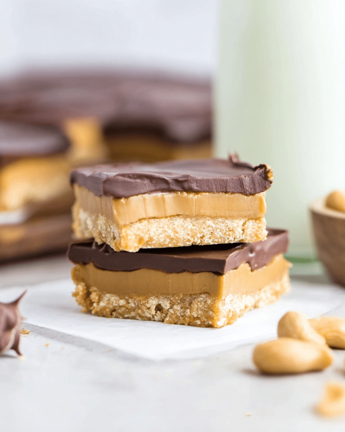 Stack of Buckeye Bars with layers of chocolate, creamy peanut butter filling, and a cookie-like base.
