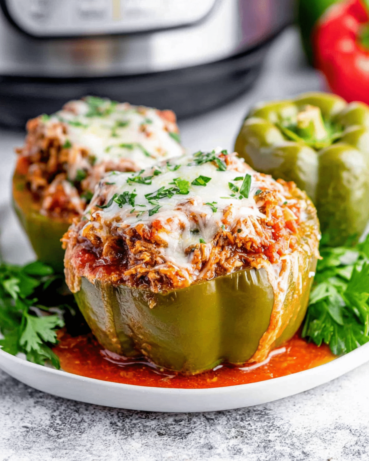 Green Crock Pot Stuffed Peppers filled with a savory meat and rice mixture, topped with melted cheese and parsley.