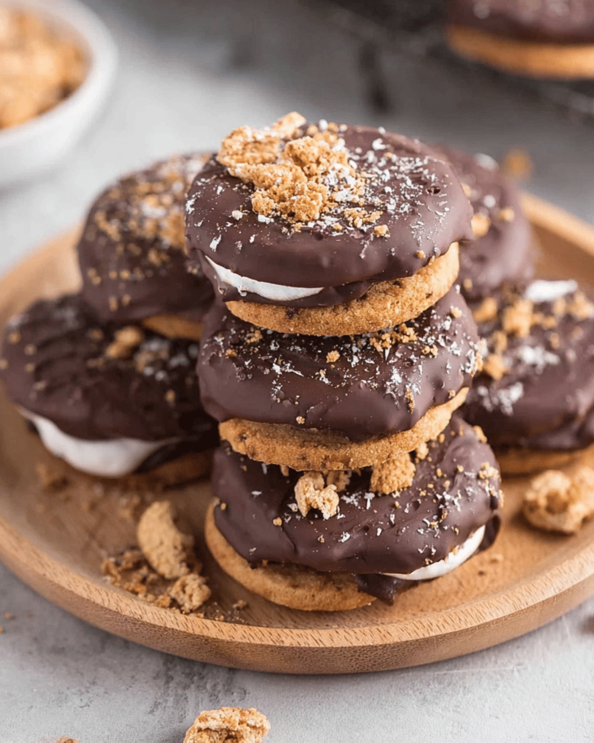 Stack of 4 ingredient Ritz S’mores cookies made with marshmallow, chocolate, and Ritz crackers, dipped in chocolate and topped with cookie crumbs.