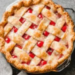 Homemade Cherry Pie with a golden lattice crust in a glass pie dish