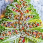 Romaine Lettuce Salad arranged in the shape of a Christmas tree with toppings and dressing