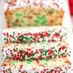 Slices of Christmas Sprinkle Buttermilk Bread topped with white icing and red, green, and white sprinkles, showing a festive interior.